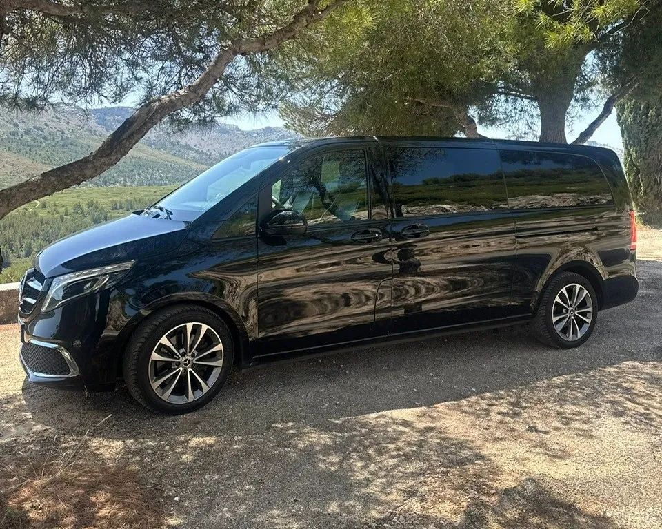 Black Massilia Services VTC Mercedes V-Class van in the shade of pine trees, in the hills around Marseille