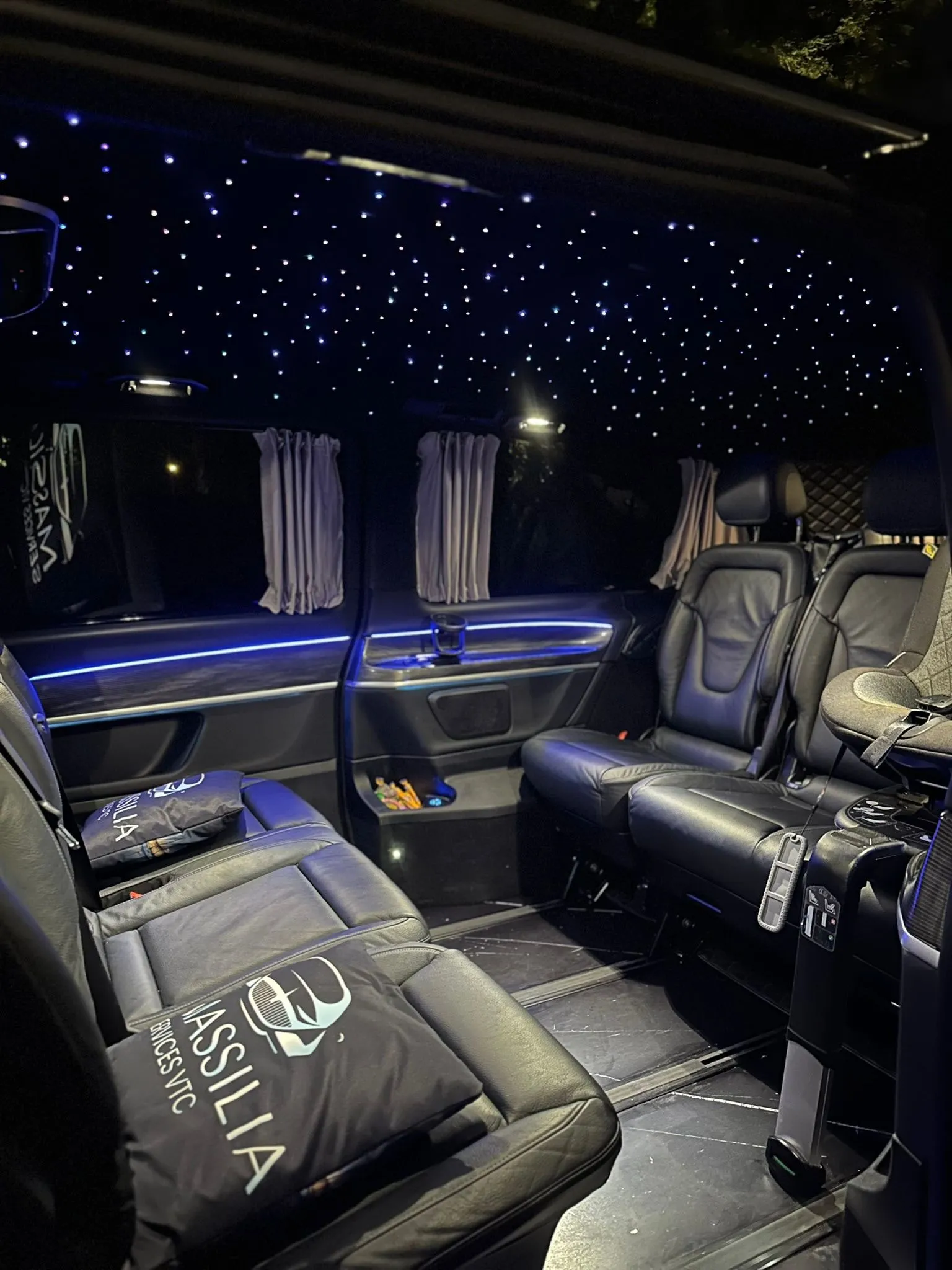 Inside a Mercedes V-Class van with starlight headliner and leather seats